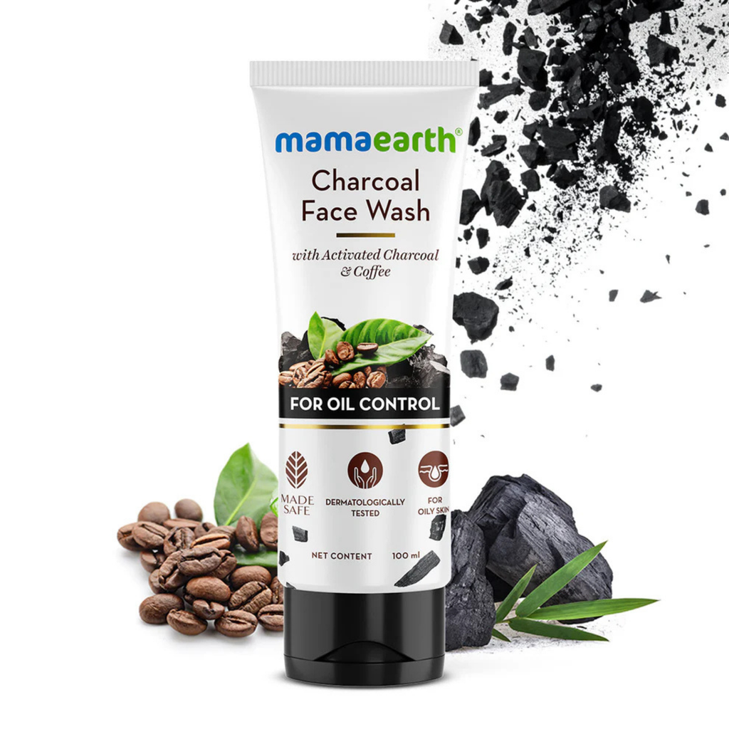Mamaearth Charcoal Face Wash packaging with activated charcoal, coffee beans, and green leaves on a white background
