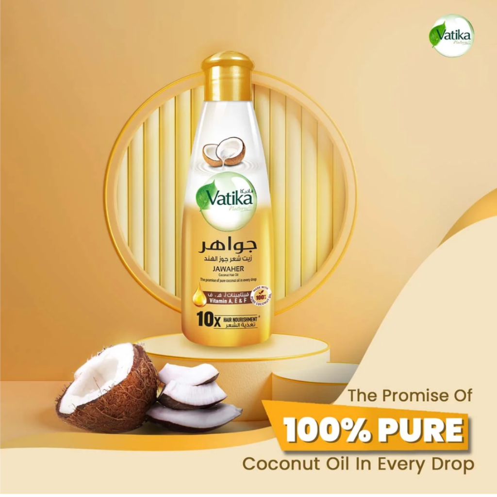 Vatika coconut oil bottle with coconuts on a yellow background