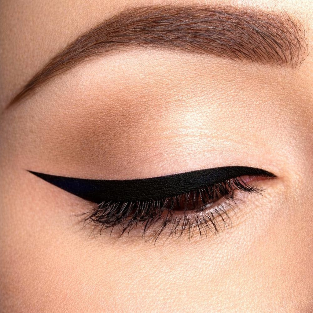 Close-up of a woman's eye with black eyeliner and brown eyebrow.