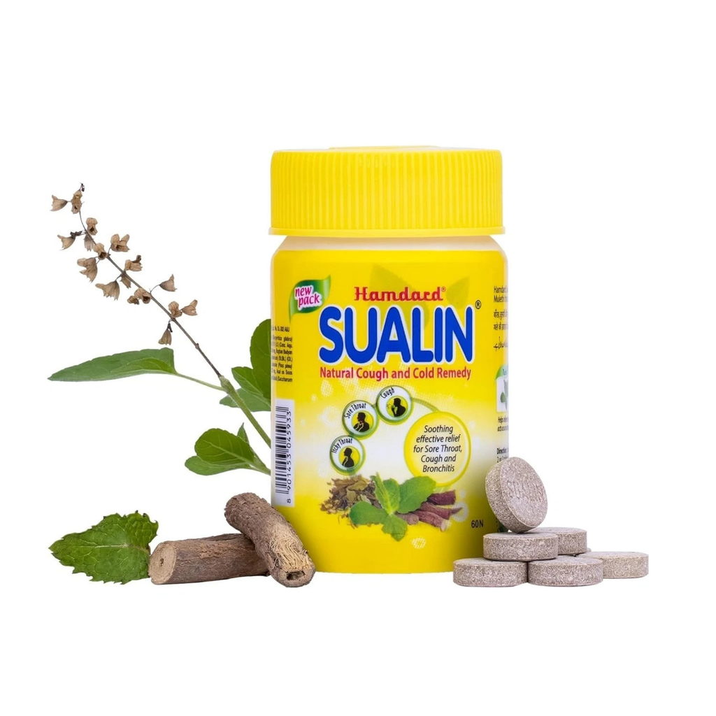 Sualin natural cough and cold remedy bottle with tablets and herbs on a white background