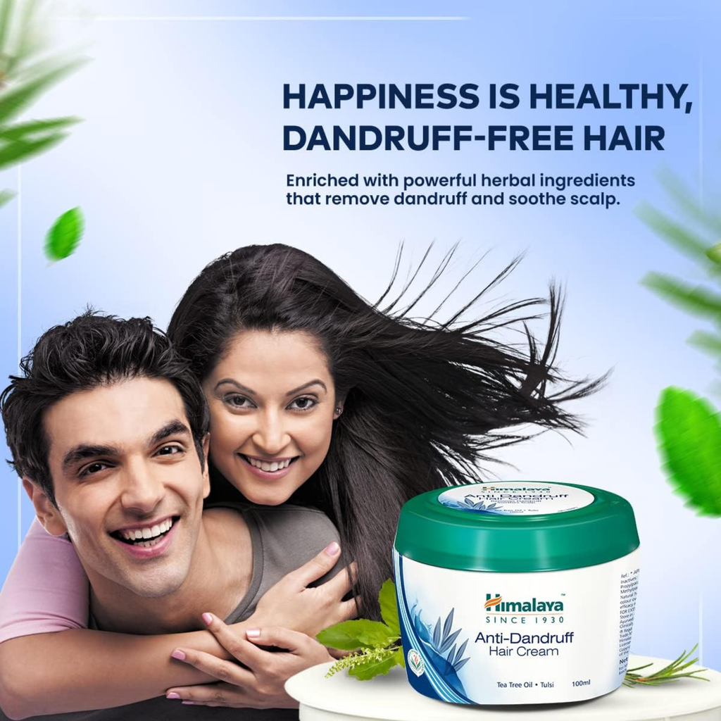 Couple with healthy hair next to a jar of Himalaya Anti-Dandruff Hair Cream on a light blue background with green leaves.