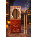 Red incense box with intricate design and two incense sticks on a blurred background of a mosque.